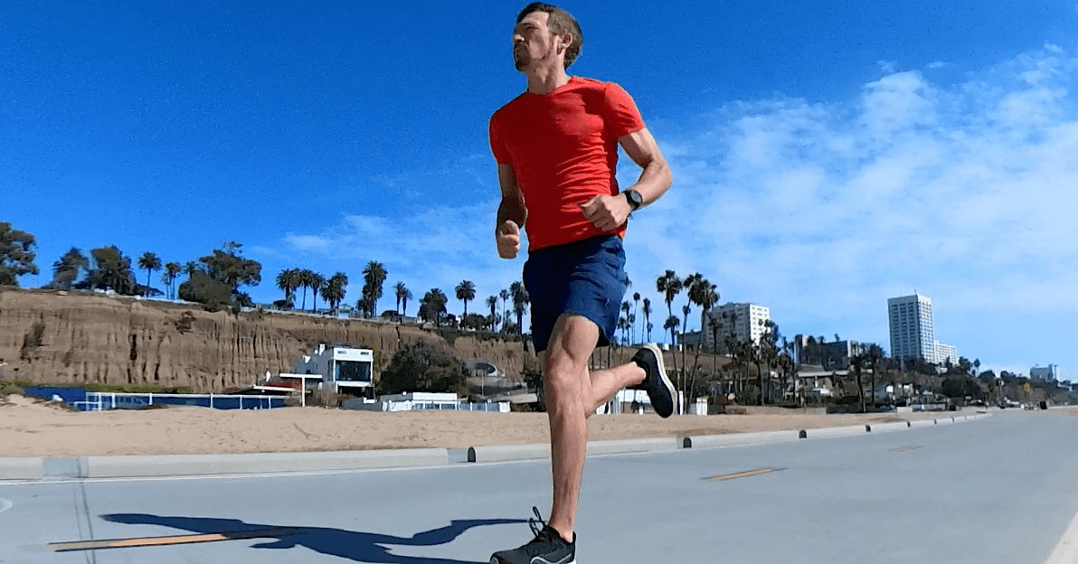 Athlete running outdoors during a sustained aerobic workout.